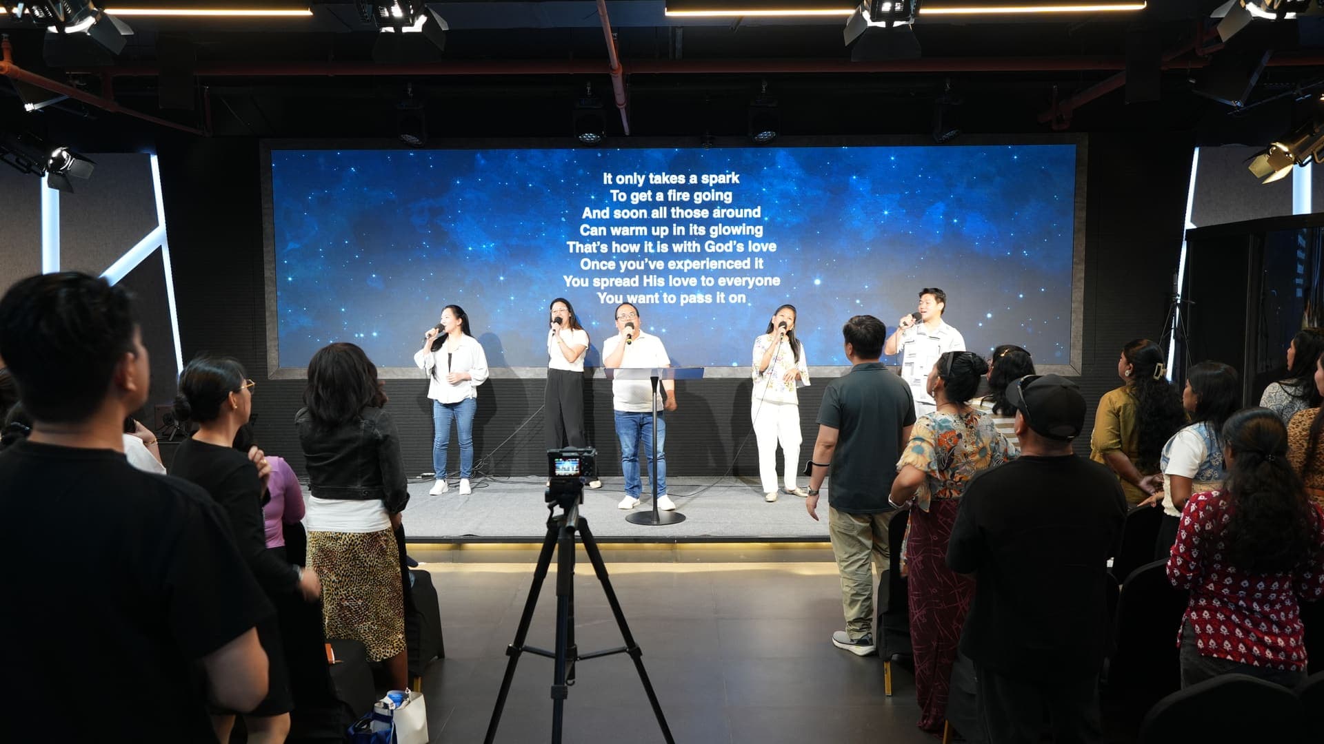 Worship team leading singing at ICOC UAE Sunday service in Oval Hall, Garhoud
